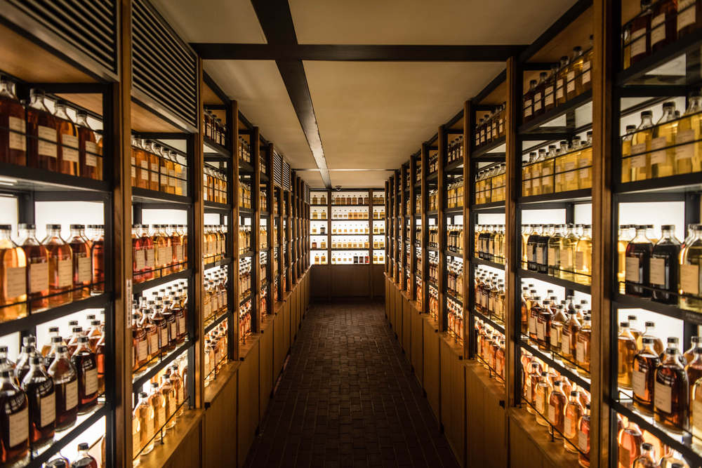 Shelves in a room full with whiskey bottles